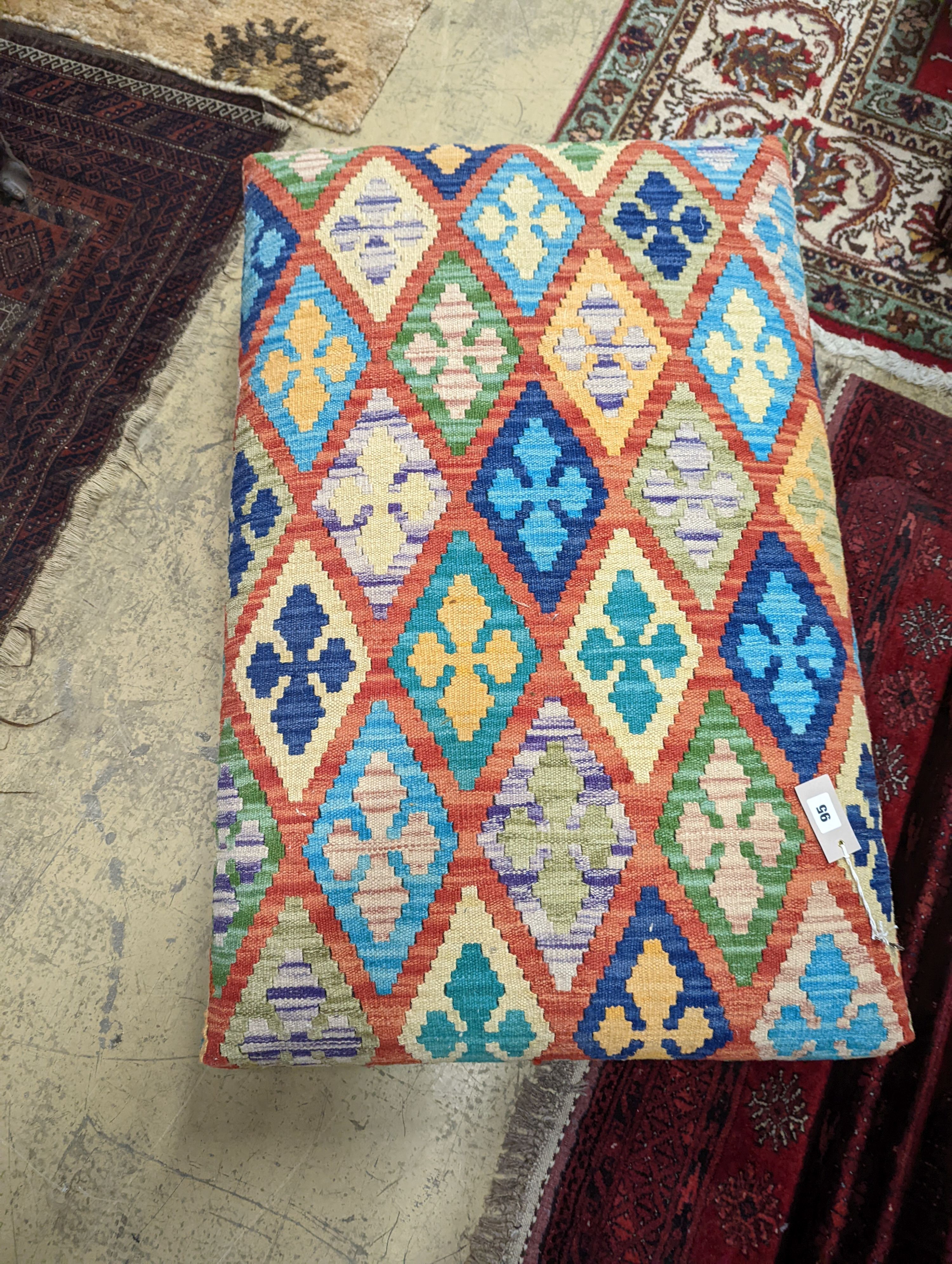 A rectangular Kilim footstool on flat bun feet, length 98cm, depth 62cm, height 22cm